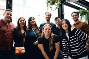 Advantage Group employees gathered together at a casual social event in a modern indoor venue