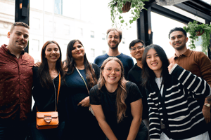 Advantage Group employees gathered together at a casual social event in a modern indoor venue