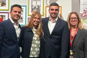 Group of professionals standing together at an awards or recognition event.