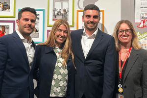Group of professionals standing together at an awards or recognition event.
