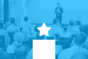 Audience attending a professional presentation, representing featured insights or discovery content