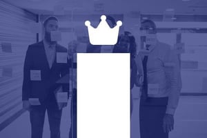 Team collaborating around a glass wall covered with notes, representing transformation and strategic planning