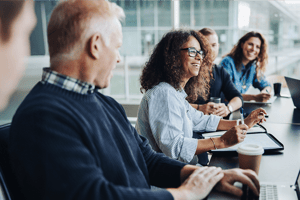 Business team collaborating at a conference table with laptops during a strategic planning meeting